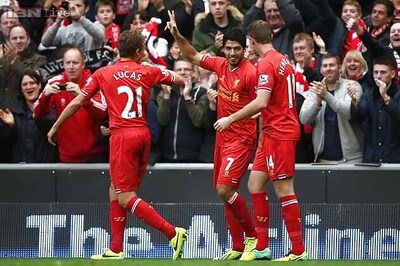 Suarez hat-trick keeps Liverpool on Arsenal's tail