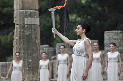 Olympic torch back on Earth after spacewalk