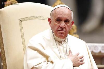 Pope washes feet of Muslim migrants, says 'we are brothers'