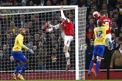 Podolski double helps Arsenal rout Coventry in FA Cup